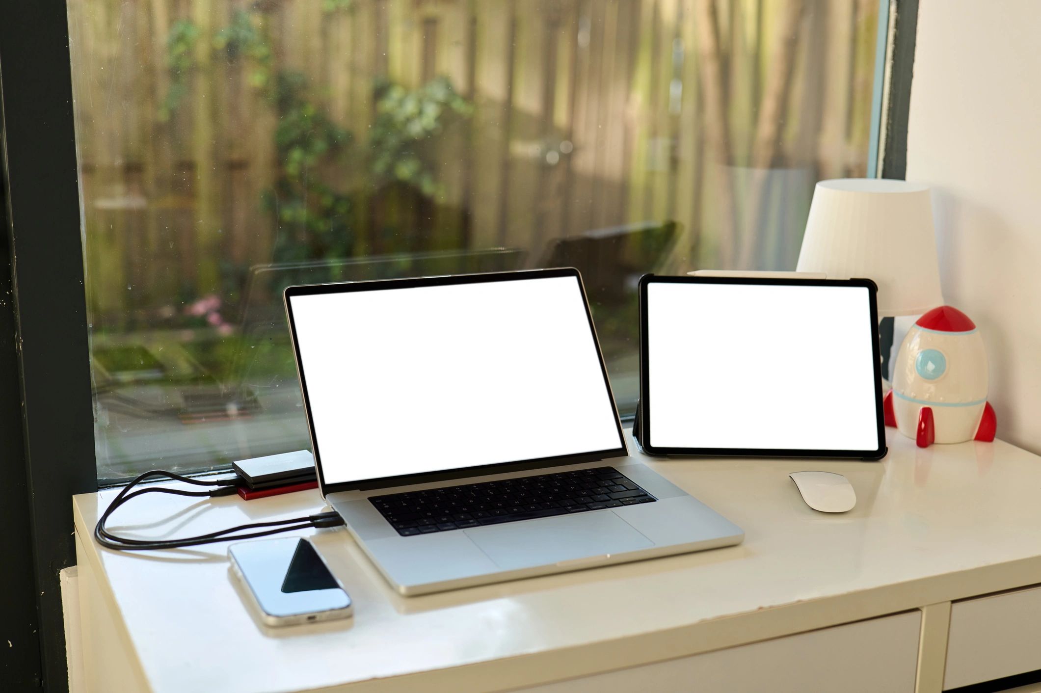 Tablet, laptop, and smartphone arranged on a modern workspace